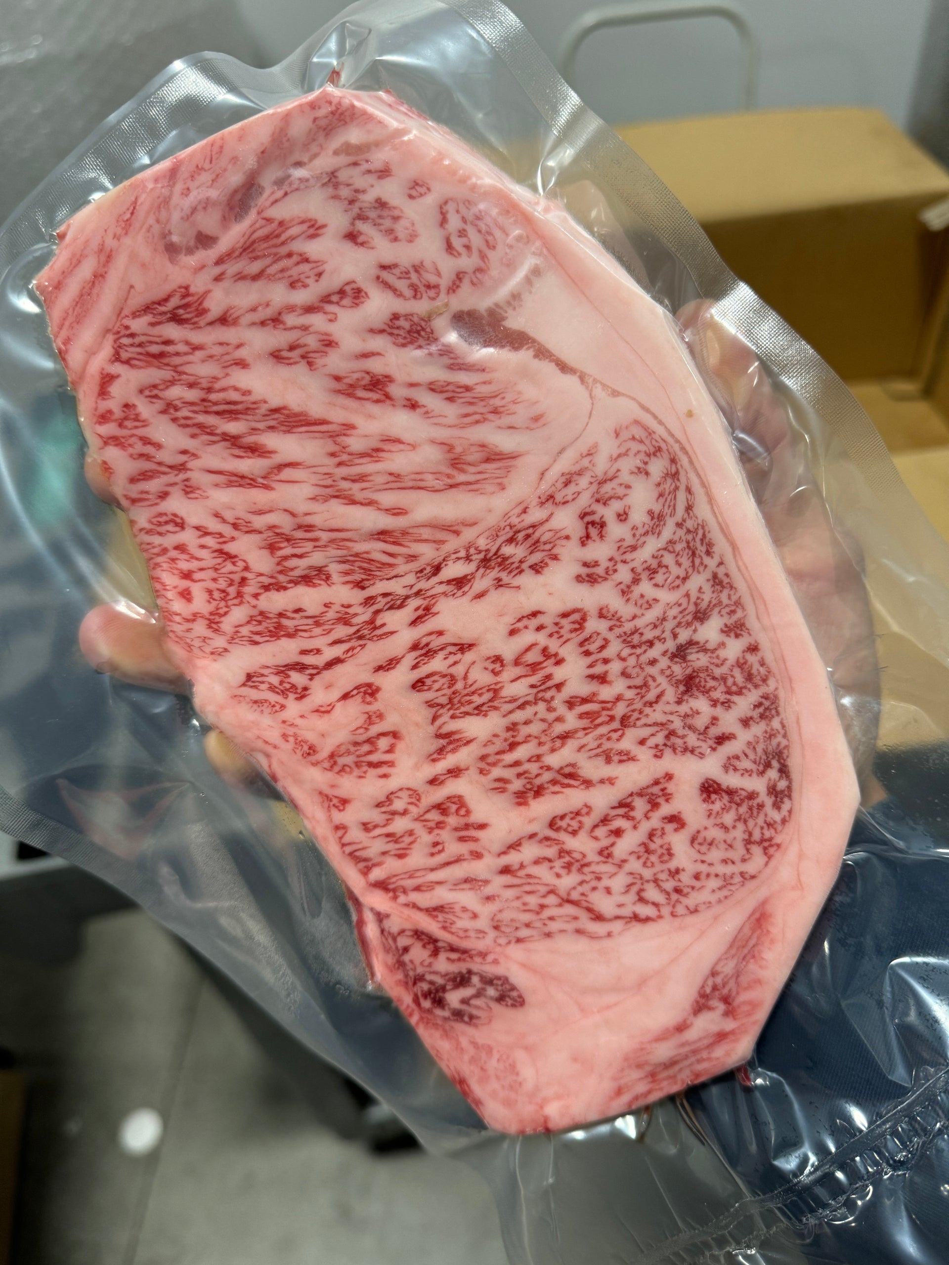 A5 Kobe Usunaga NY Strip — BMS 8-12 Japanese A5 Wagyu, Hyogo Prefecture (Kobe Beef) — cooked and sliced