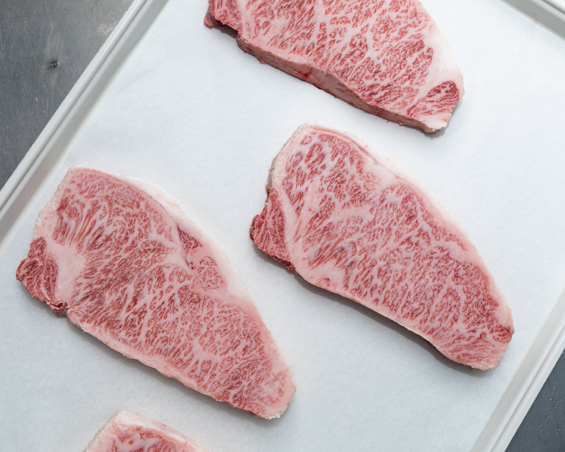 A5 Miyazaki NY Strip — BMS 8-12 Japanese A5 Wagyu, Miyazaki Prefecture — cooked and sliced